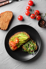 Tasty toasts with avocado on plate