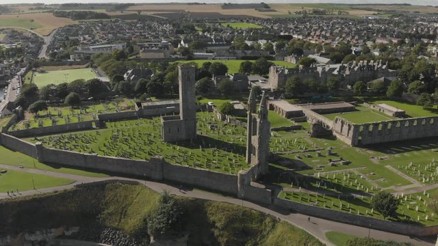 Aerial view orbiting the St Andrews Cathedral and cemetery grounds in St Andrews, Scotland, UK. ESTABLISHING, ORBITING shot. 4K footage shot on Mavic Air.
