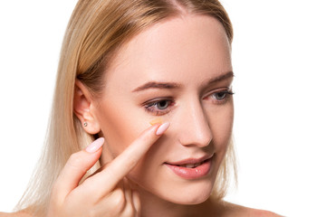 Fototapeta premium Young woman holding contact lens on index finger with copy space. Close up face of healthy beautiful woman about to wear contact lens.