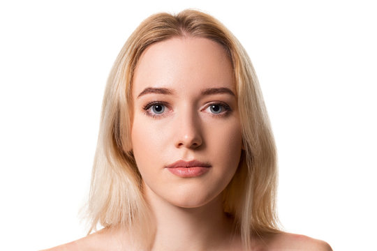 Young blonde woman without makeup on white background
