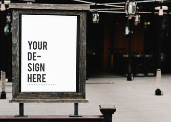 Rustic wooden signboard mockup at a restaurant - obrazy, fototapety, plakaty