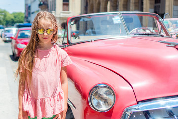 Tourist girl in popular area in Havana, Cuba. Young kid traveler smiling