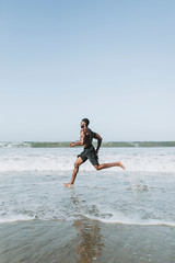 Fit man running at the beach
