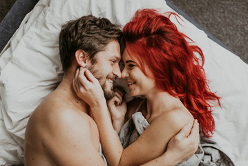  beautiful loving couple kisses in bed