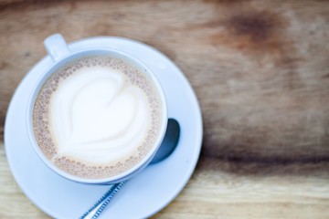cup of coffee on wooden table