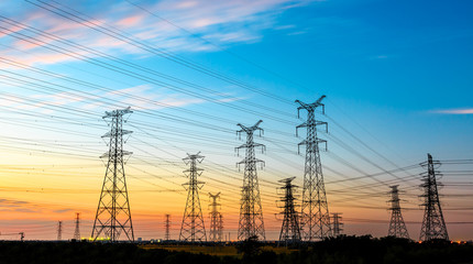 high-voltage power lines at sunset,high voltage electric transmission tower