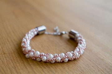 Pearl bracelet on wooden table
