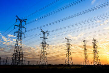 high-voltage power lines at sunset,high voltage electric transmission tower