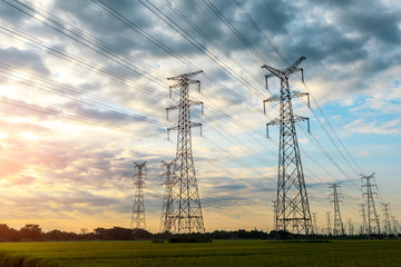 high-voltage power lines at sunset,high voltage electric transmission tower