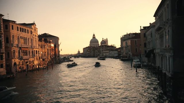 Italian port. Sunset. Tourist boats sailing on the river