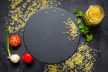 pasta aneli - a set of ingredients for cooking pasta  (dark background). top view. copy space