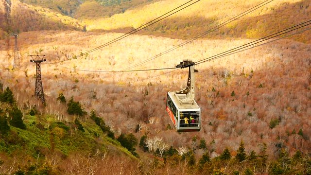 Travel video Hakkoda ropeway in Aomori Prefecture with Autumn Leaves background A wonderful view of hakkoda mountains. Take the visitors to the top of Mt. Hakkoda in travel and transportation concept.