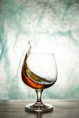 Cognac in a glass goblet on a wooden table
