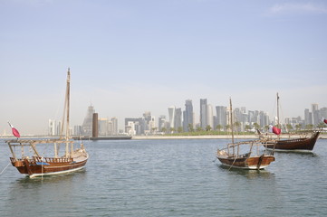 Fototapeta na wymiar The skyline of the city of future with old boats in the bay