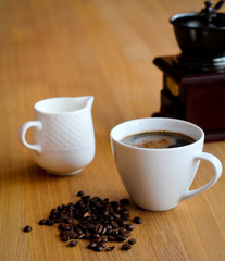 Aromatic fresh coffee in porcelain cup  on wooden table