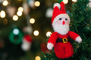 Knitted Woollen Santa Claus decoration on a Christmas tree