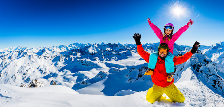 Happy family enjoying winter vacations in mountains . Ski, Sun, Snow and fun.