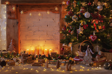 Magical Christmas setting, decorated fireplace with wooden mantelpiece fire surround, lit up Christmas tree with baubles ornaments, stars, lights, candles, toned, vintage effect selective focus