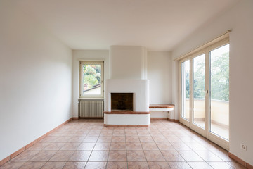 Empty room with fireplace and windows with a view.  Front photo shoot. Nobody inside.