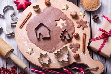 Baking gingerbread cookies, christmas cookies, raw dough and cutters, flat lay, top view