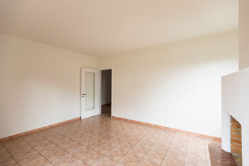 Empty room with open door, natural light