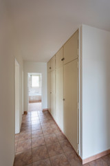 Corridor with vintage tiles and white closet