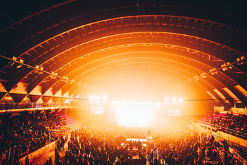 Crowd at music concert, orange light