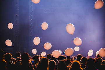 Balloons flying over the crowd during the concert. Live show