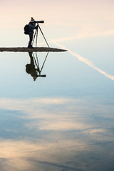 Silhouette and reflection of photographer in Bahariya salt lake