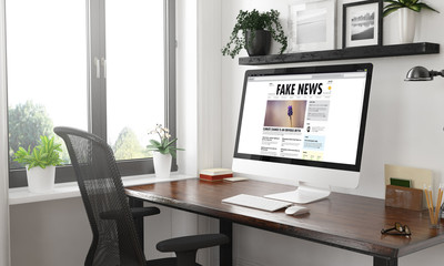 black and white fake news computer on desktop