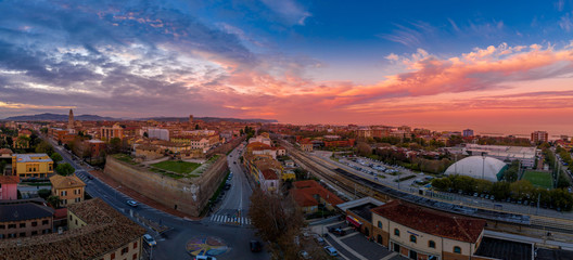 Aerial panorama of popular travel destination beach town Fano in Italy with sunset blue, red,...
