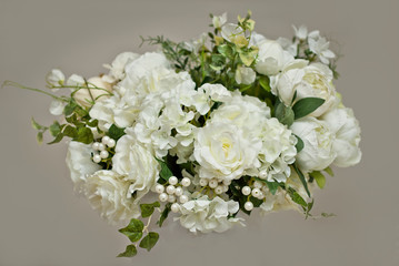 Bouquets of white roses, chamomile and other flowers on a white background.