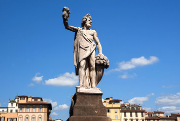 Fototapeta na wymiar Dionysus sculpture standing on street of Florence. The god of the grape-harvest, winemaking and wine under the streets of historical Firenze, Italy