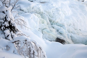 Fototapeta na wymiar frozen waterfall Tannforsen in winter, Sweden