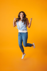 Fototapeta na wymiar Full length portrait of an excited young casual woman