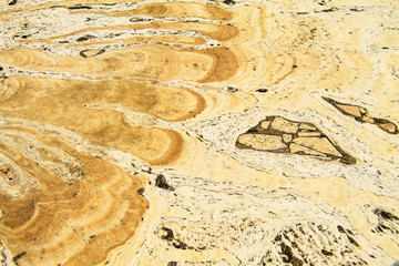 Unusual pattern on the smooth surface of the yellow old stone, stone background, decoration material, floor design, texture, marble wall, kitchen and bathroom tiles, website background