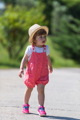 Fototapeta premium little girl runing in the summer Park