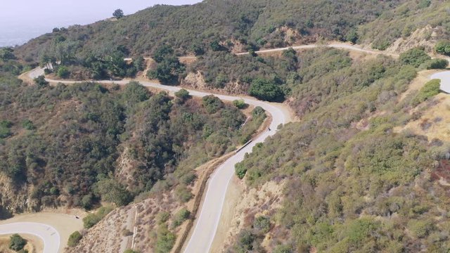 Tracking motorcyclist going down curvy mountain road