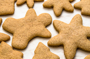 Home-baked gingerbread on a kitchen surface with baking paper - Christmas concept with home-baked cookies in the kitchen