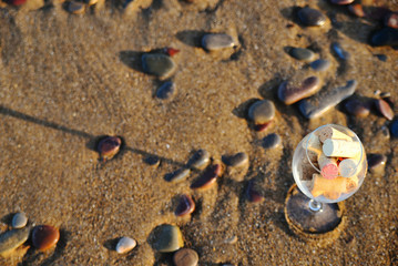 Wine glass with cork stoppers on the beach