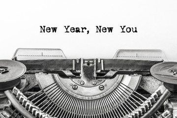 New Year, New You! Text is typed on a vintage typewriter on a white background. Close-up.