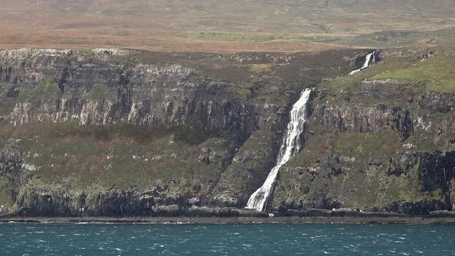 Waterfall on the left stopped and reversed by autumn storm Callum on the cliffs seen from Lower Milovaig - Isle of Skye, Scotland
