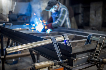 Metal construction on the stocks is processed by the welder