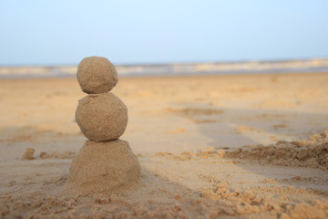 Sand snowman for those who celebrate New Year by the sea or ocean