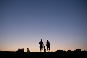 Fototapeta na wymiar family silhouette at sunset