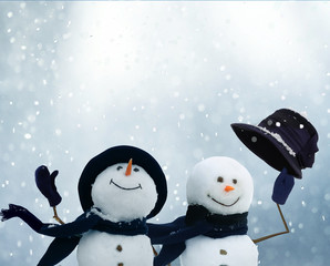 Merry Christmas and happy New Year greeting card with copy-space.Two snowmen standing in winter...