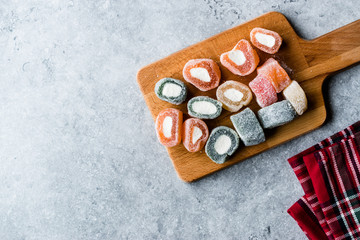 Fruity Turkish Delight Roll Shaped on Wooden Board.
