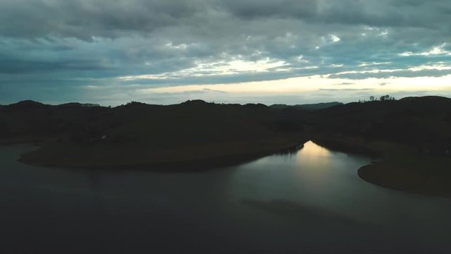 drone sunset flight over reservoir in brazil