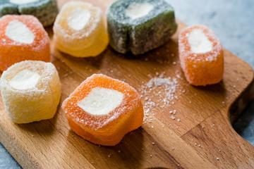 Fruity Turkish Delight Roll Shaped on Wooden Board.