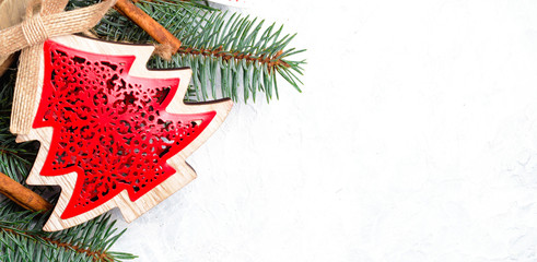 Christmas decorations and branches of a New Year tree on abstract background